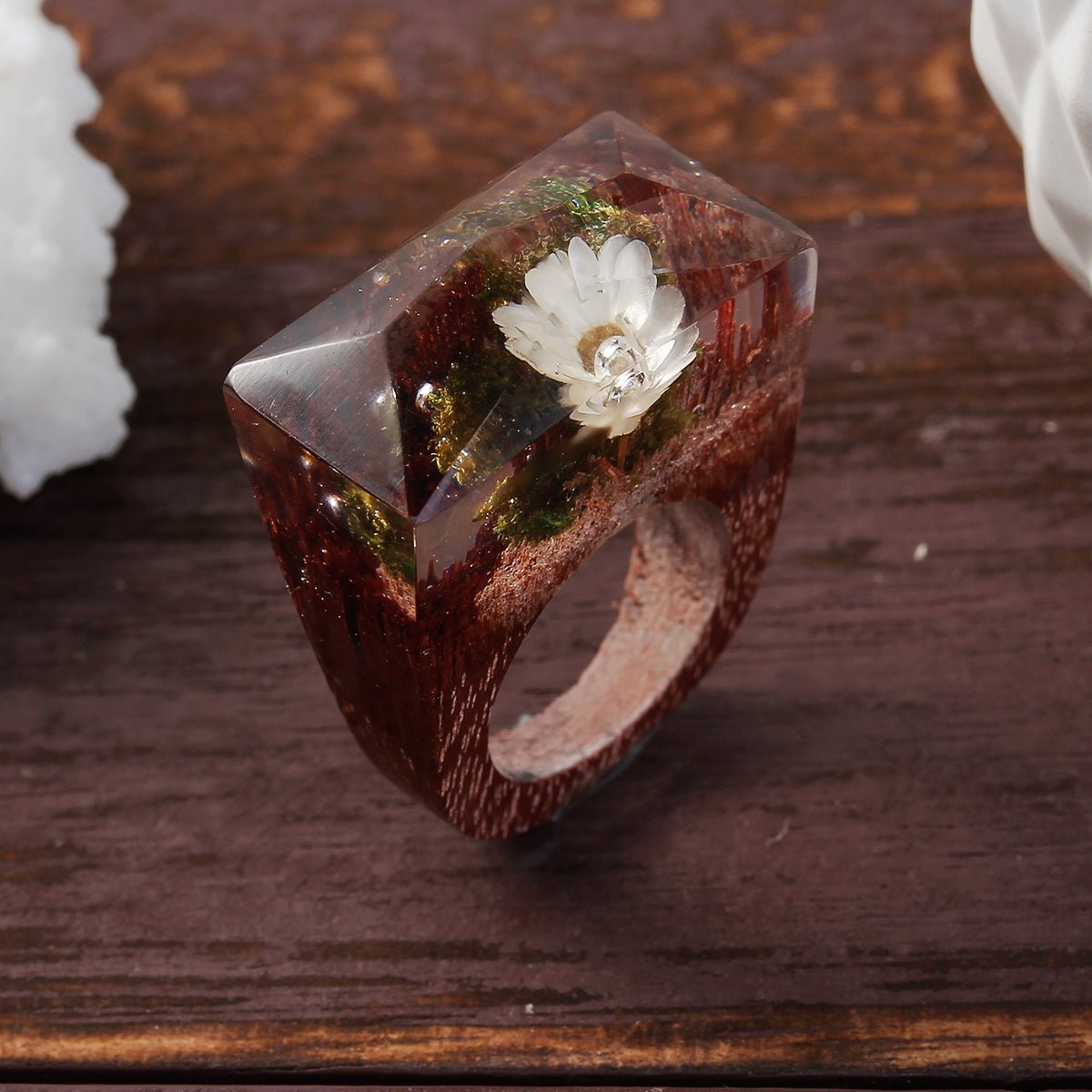 handmade wooden ring with dried flower inside of it