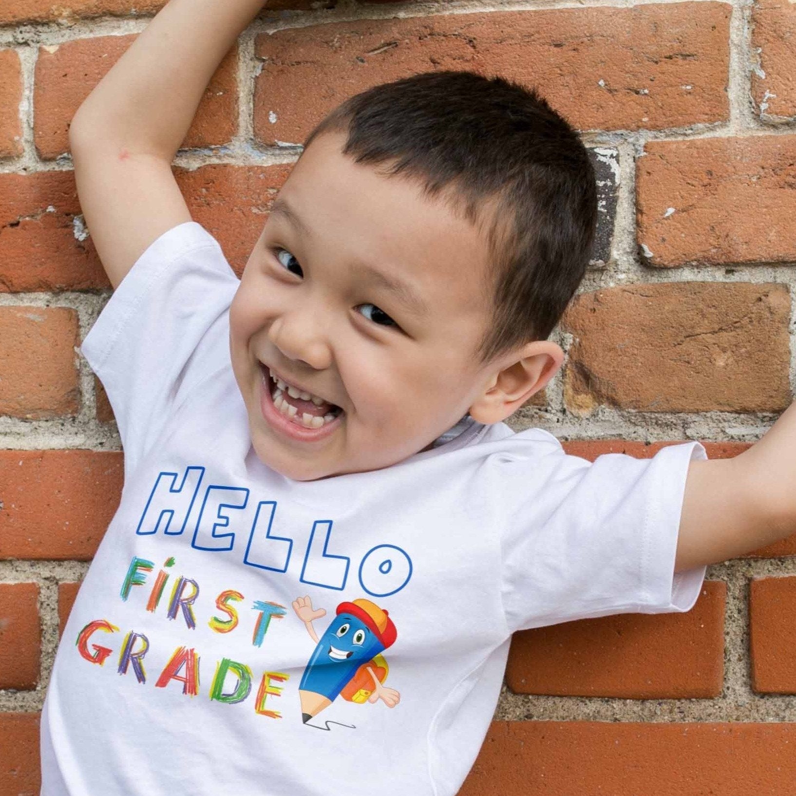 Happy boy wearing a colorful hello first grade t-shirt