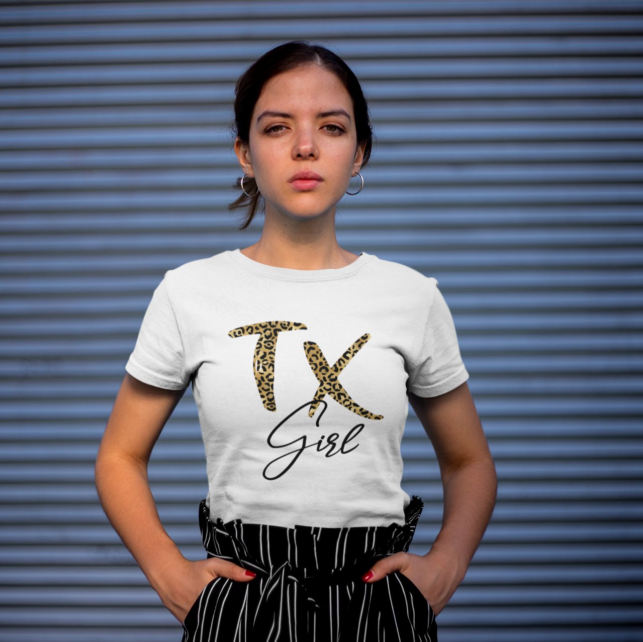 Woman wearing a TX girl t-shirt. The TX is leopard print.