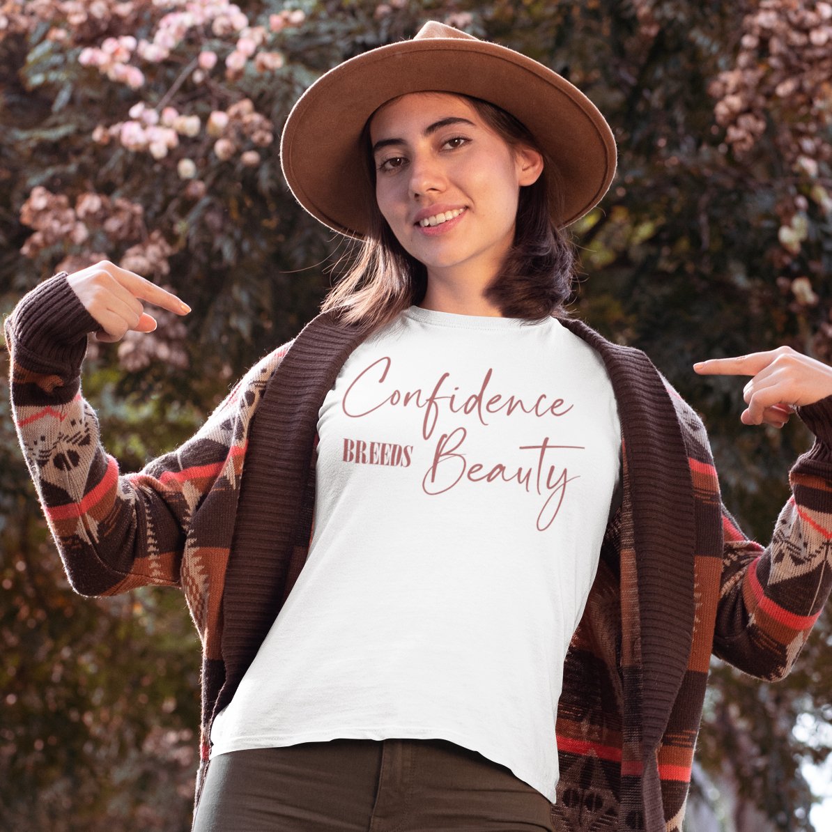Woman wearing a confidence breeds beauty in a rose color print t-shirt