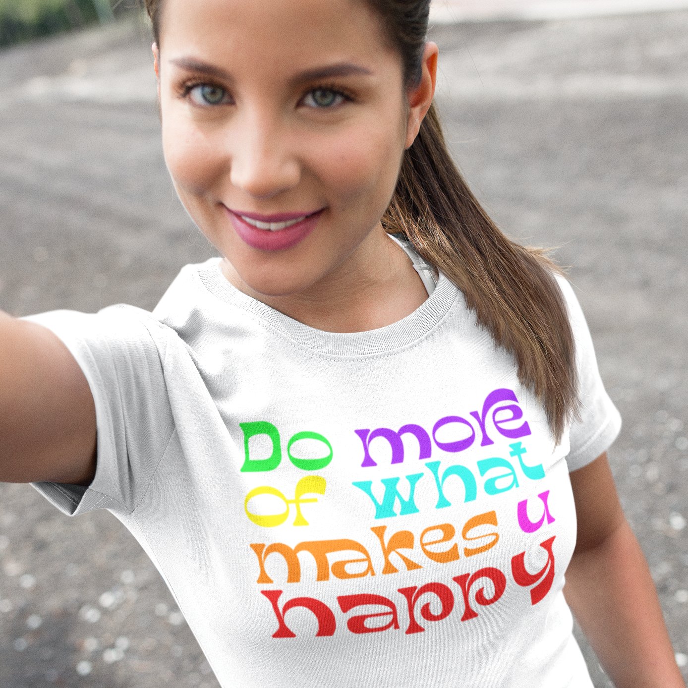Woman wearing a colorful do more of what makes you happy t-shirt