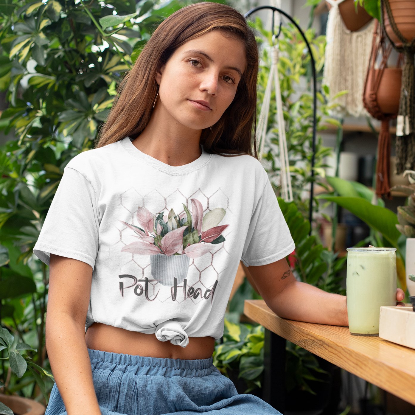 Woman wearing a pothead t-shirt with a plant on it