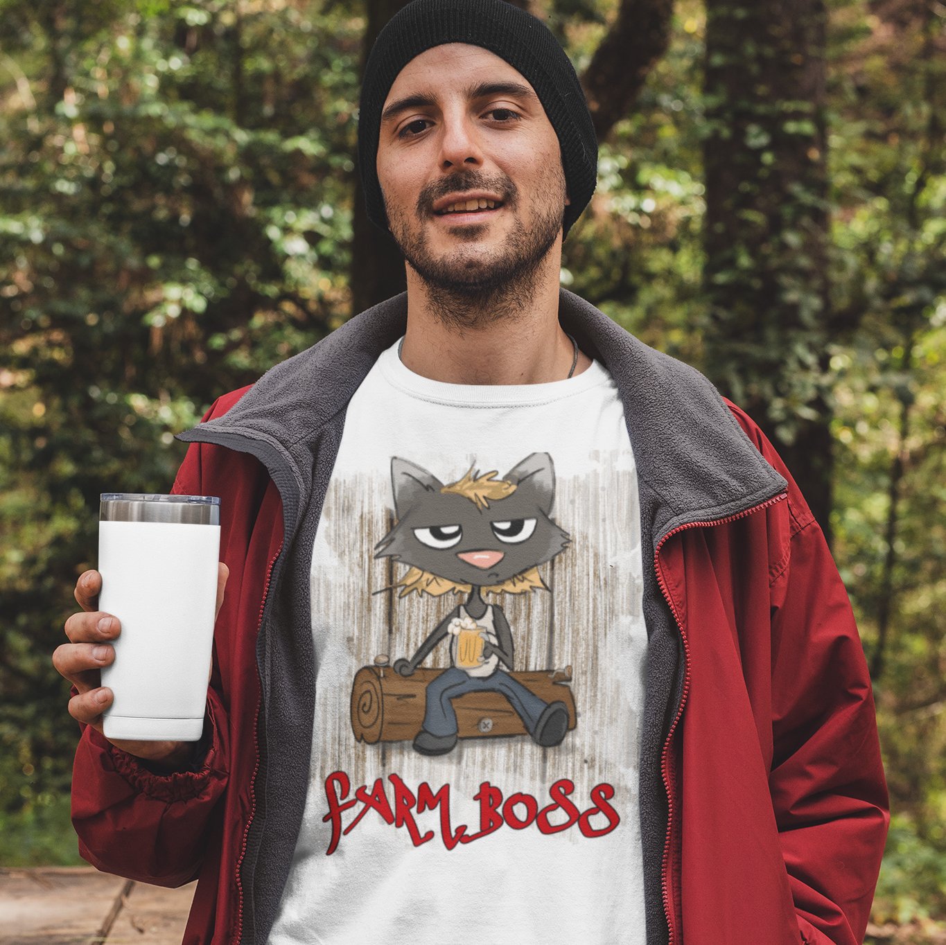 Man wearing a Farm Boss t-shirt with a funny cat sitting on a log on it